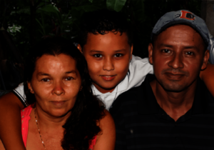 Tonito in between his mother & father