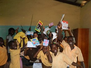 children excited after receiving books from team