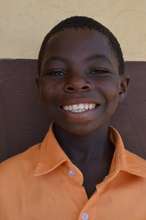 Emmanuel after being sponsored to school
