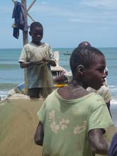 Children mending fishing nets.