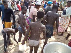 Some children working and struggling at the shore