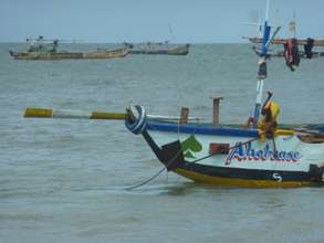 A child diving to check fishing nets on shore