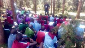 Boys learn under the shade of the trees