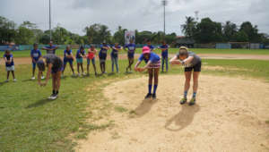 Coach Brittany co-leads a stretch with a player
