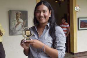 Reyna receiving Outstanding Female Athlete award.