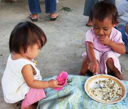 Filipino children eating mungbeans & rice