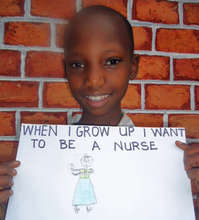 Lakiel holding a picture of herself as a nurse.