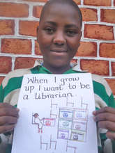 Sarah and her drawing of herself as a librarian.