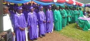 Grauating Girls Standing Beside Their Male Peers