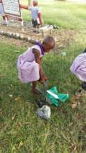 Primary student putting on the shoes you gave her