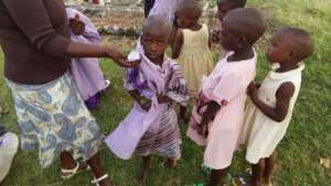 Nursery students putting on the uniforms you gave