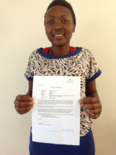 Shirah holding her acceptance letter to VIU