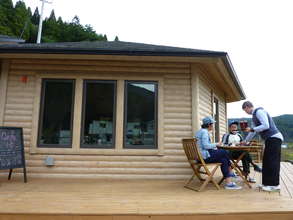 Volulnteer serving drinks & sweets to locals