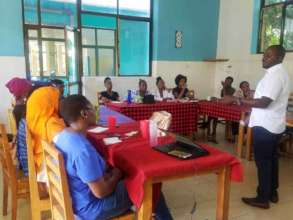 Mr. Niyimpaye Kataze leads training at AfricAid