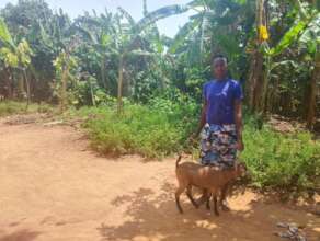 Justine with her goat, a symbol of her success