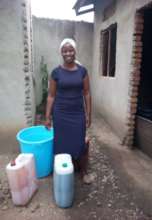 Yolesi with the liquid soap she produces.