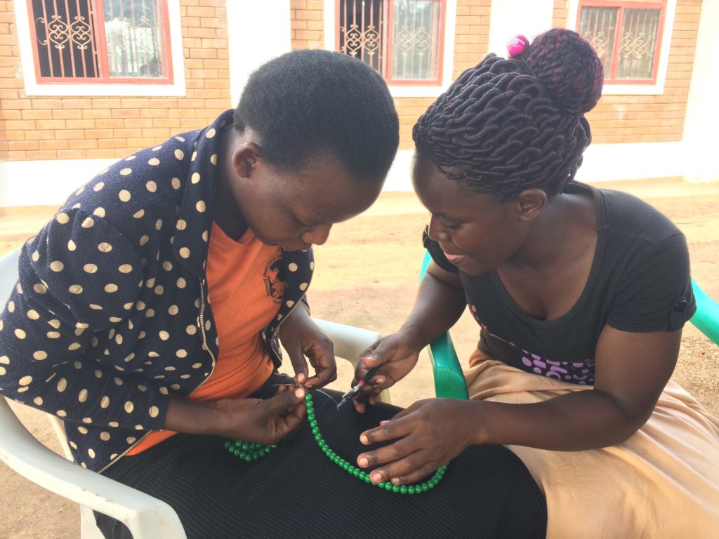 Young mothers learning jewelery making skills