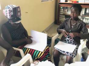 Adolescent mothers making counter books to sell