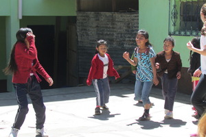 Girls playing soccer in front of the school
