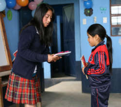 Big and Little Sisters Exchanging Personal Books