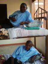 Boys in their temporary dorm (an empty classroom)