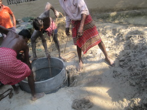 Concrete rings laid and course sand poured around.