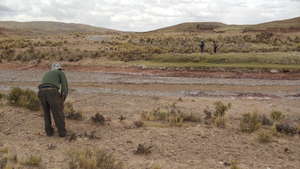 Community members measure distance for piping.
