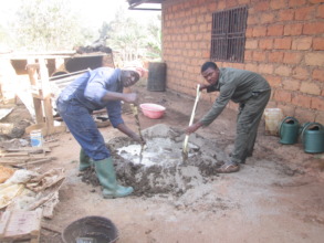 Hired workers mixing sand and cement
