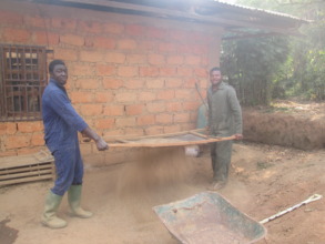 Hired workers sieving sand