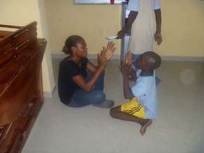Tope (Support Worker) plays with Ted*