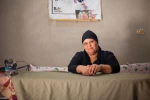 A B'edaya mother poses for a picture in her home.