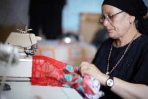 A mother sewing as part of her B'edaya project