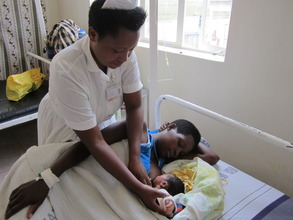 midwife reviewing mother and baby