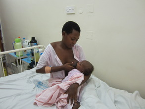 Mother breast feeding her golden baby