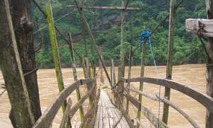 The river came high and damaged the walking bridge
