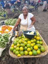 Catherine at her business place selling fruits.