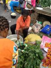 Jennet selling her vegetable in the market