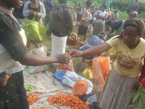 Beneficiary serving a client at the market square
