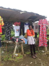 Violet standing in  front of her shop