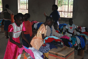 Distributing clothes that were donated to the kids