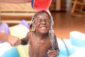 One of the orphanage children loving the water.