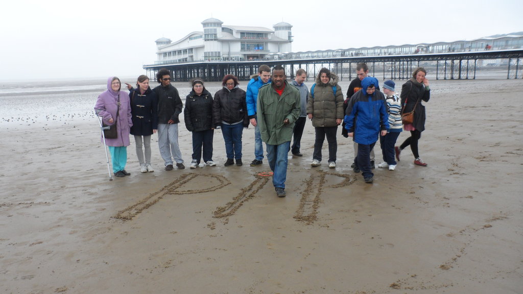 Students apply their literacy skills in the sand..