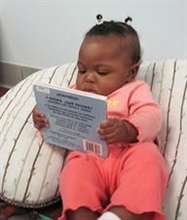 baby girl with a book