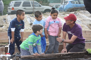 Kids learning to plant lettuce