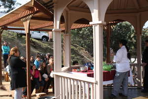 A cooking demo is held in the outdoor classroom