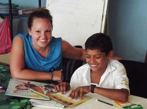 Volunteer helping grade 5 student with his reading