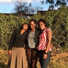 Alumnae laugh with MGEF Kajiado staff Member
