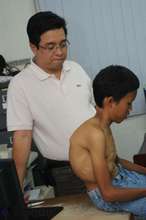 Dr. Cauilan examines child with an 80 degree curve