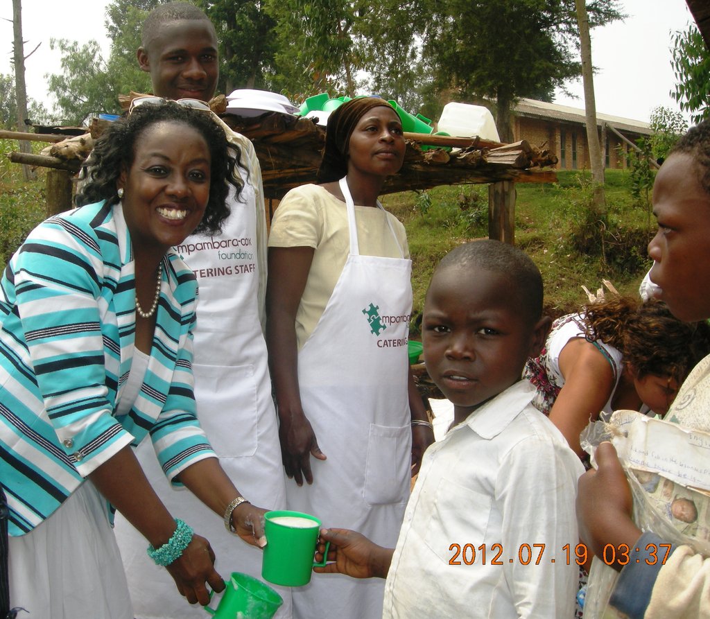 MCF President serves porridge at Nyamiyaga Primary