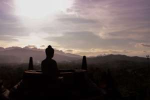 A Buddha statue at sunset in Borobodur, Indonesia